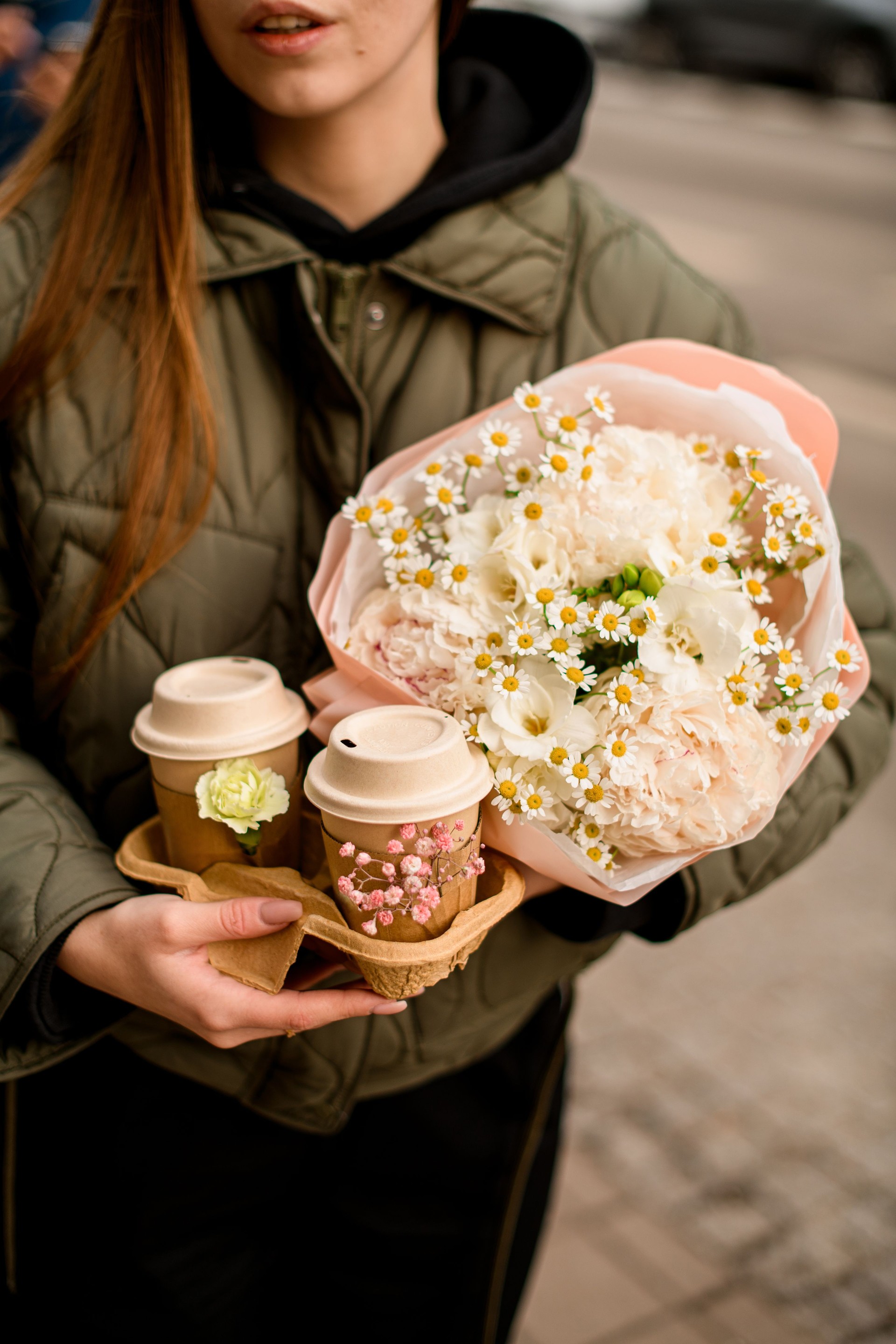 Cappuccino in the hands of a girl with a long straight hair